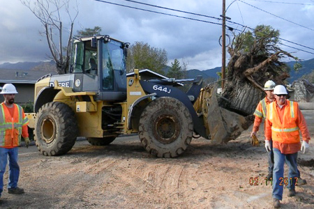 OandM_2 Truck carrying stuff away while men walking around the area.